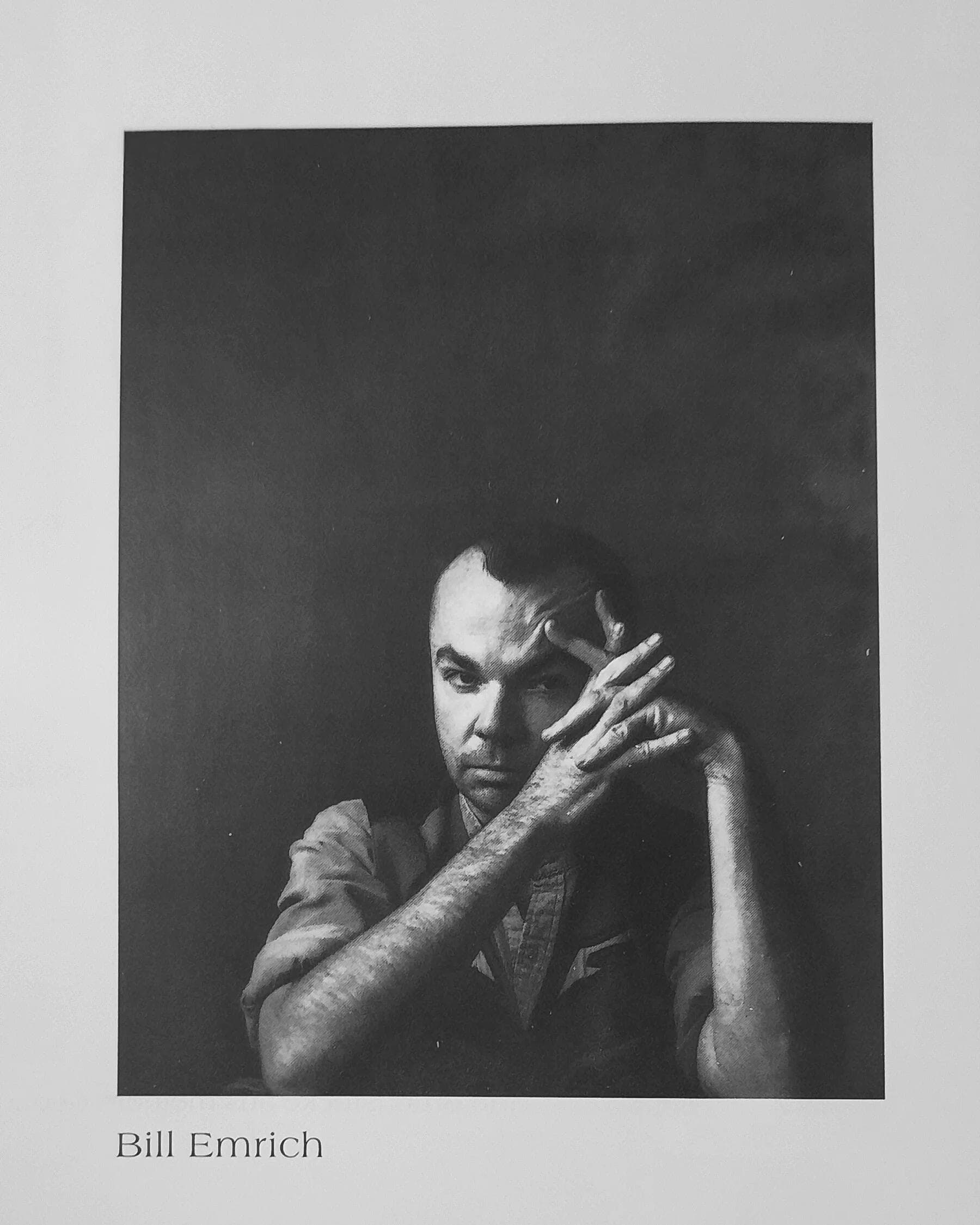 A soulful black and white self portrait of BILL EMRICH, emphasizing the use of chiaroscuro to highlight personal intensity and the intellectual depth of the artist.
